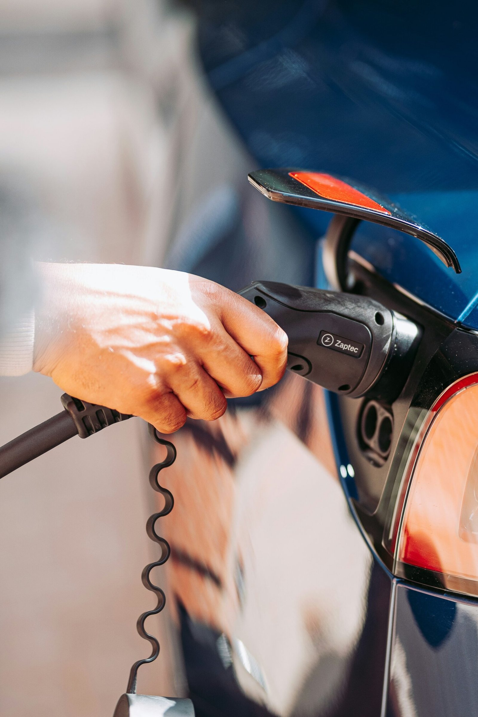 A person is pumping gas into a car